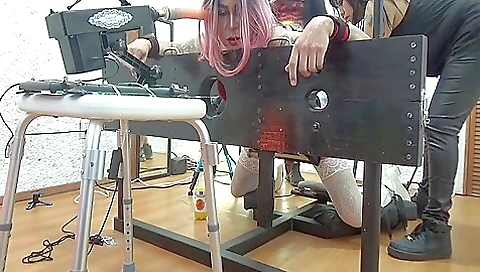 A blonde in bondage is getting on her knees to take a dick